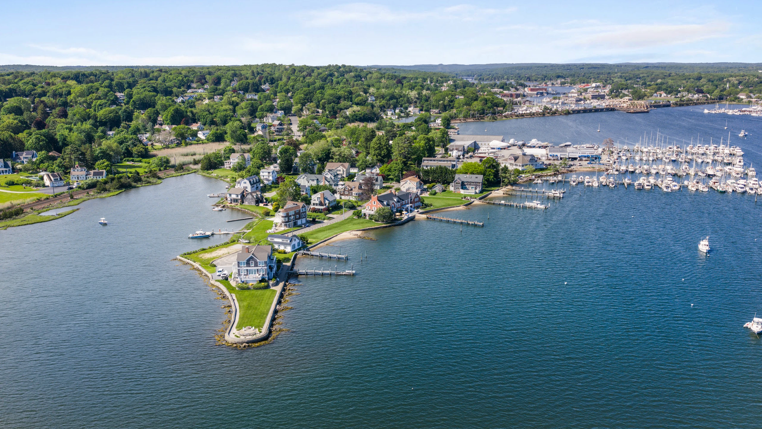 Aerial view of Willow Point with the residence, cove, marina, and surrounding shoreline.